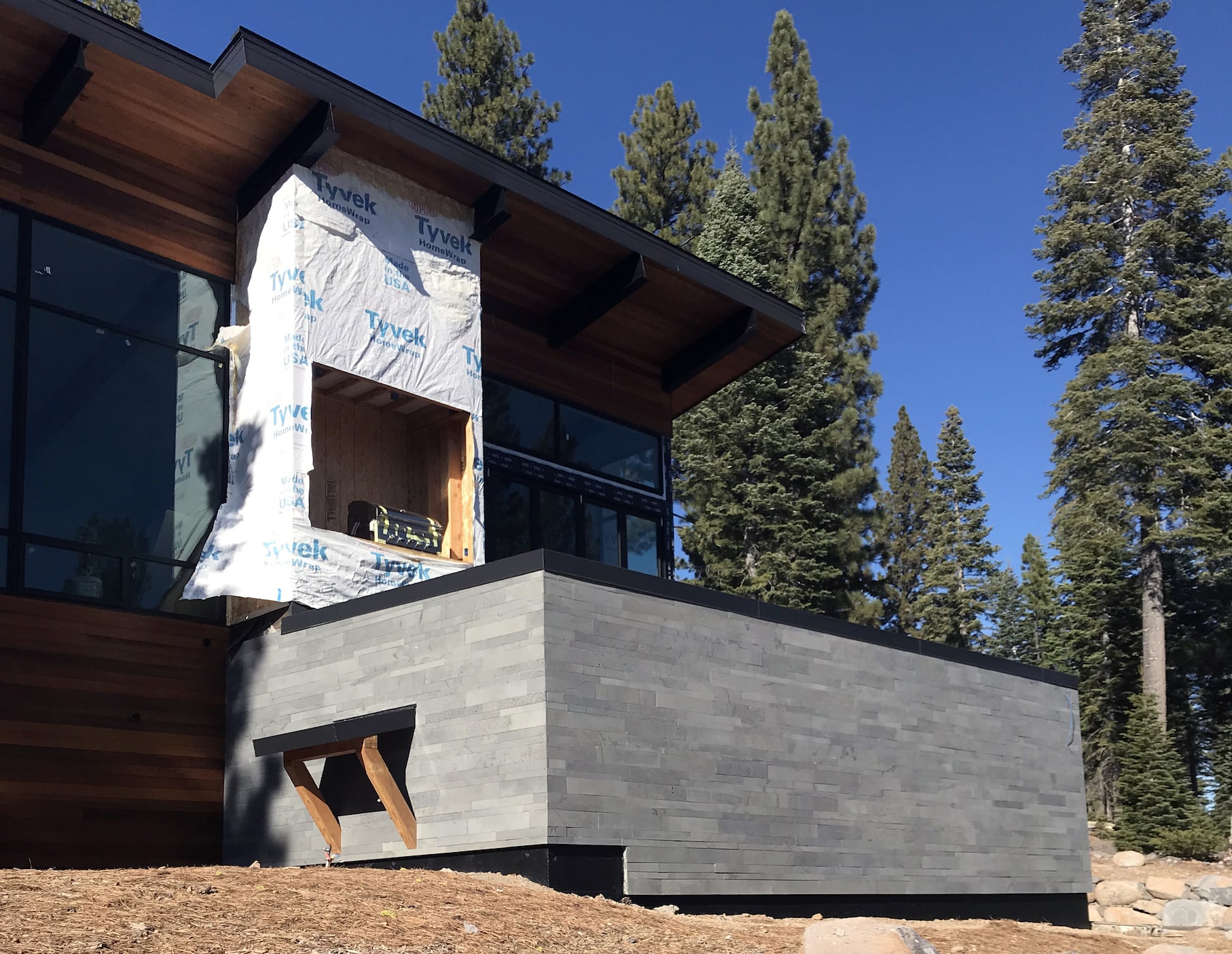 Norstone Platinum Planc Large Format Tile on a residential exterior feature wall on a hillside home in Reno